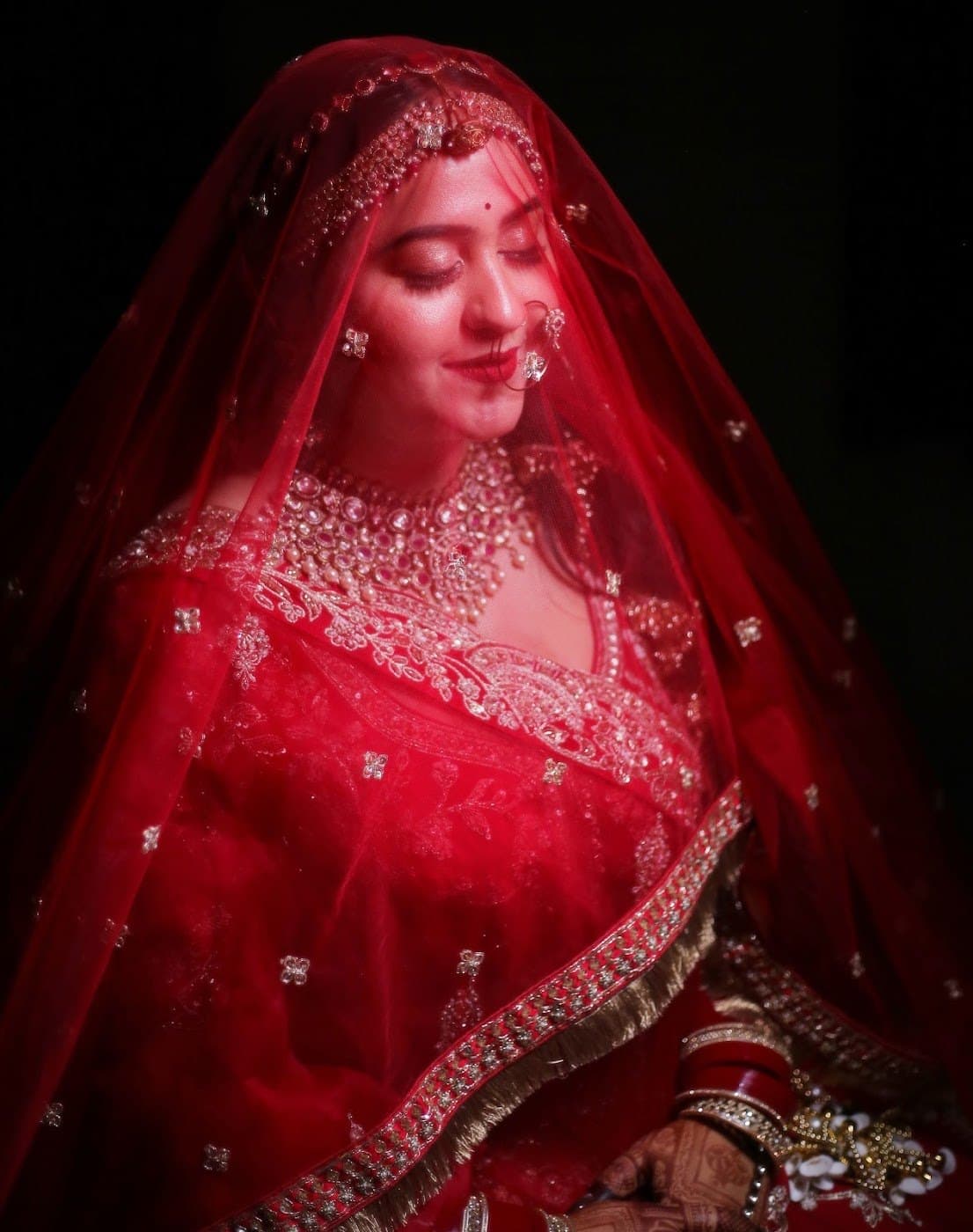Bride under a red veil